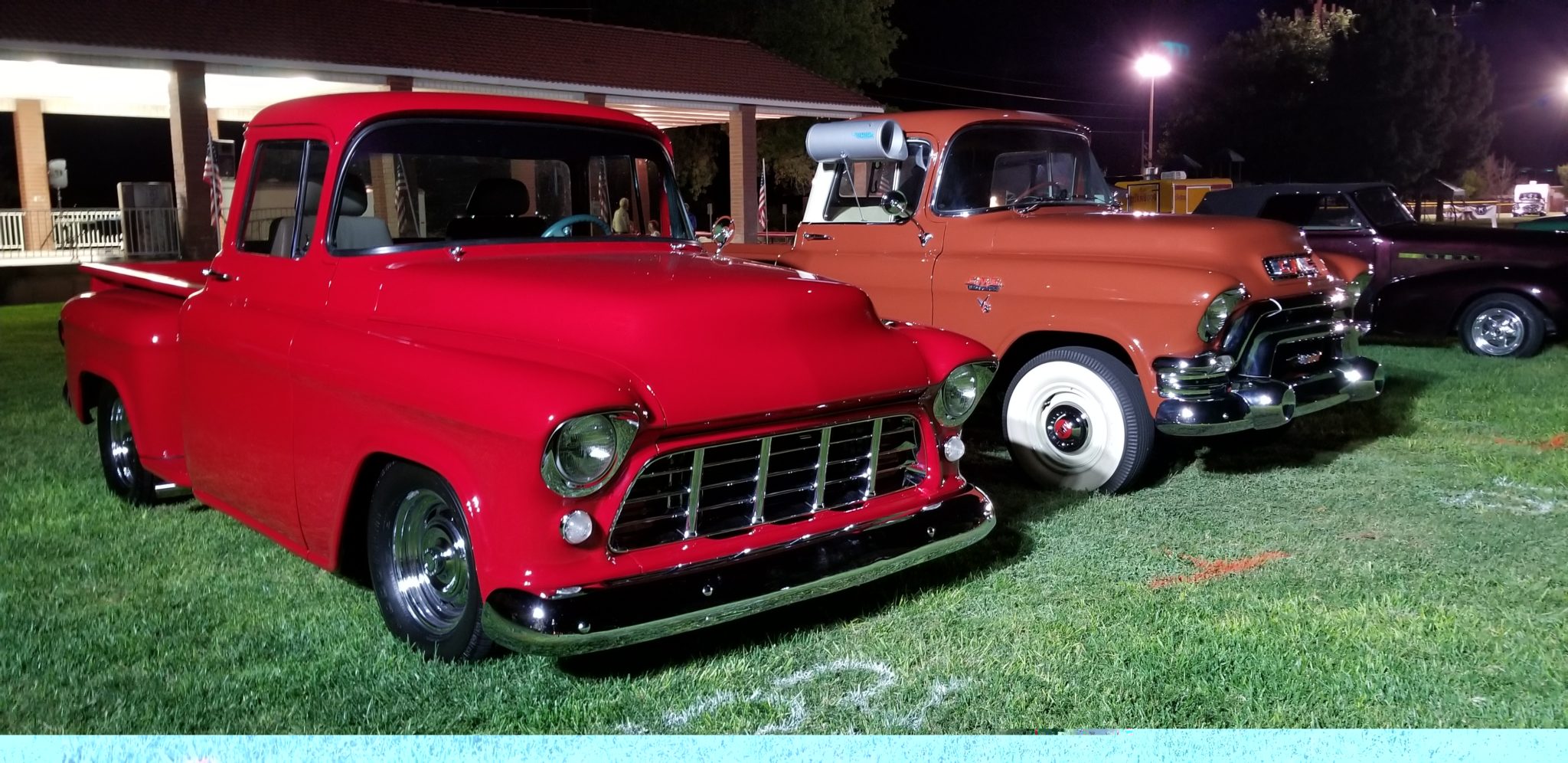 Red classic Chevy truck at night car show
